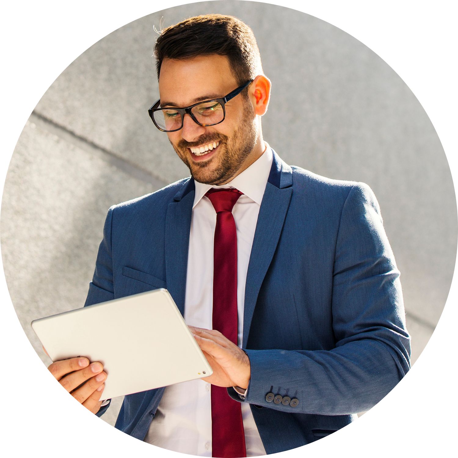 A man in a suit reading an iPad while walking